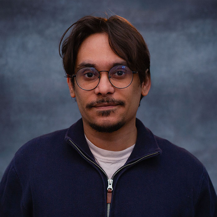 Man with glasses and brown hair.